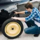 full shot man changing car tire 80x80