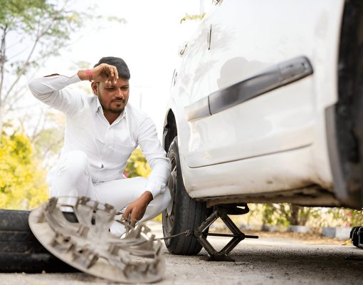 tyre puntured of man sitting on road tyre puntured of man sitting on road